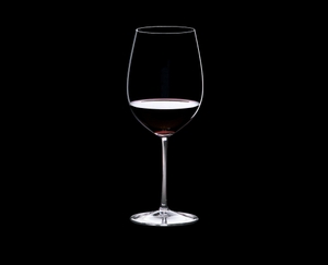RIEDEL Sommeliers Bordeaux Grand Cru R.Q. Set/4 filled with a drink on a black background