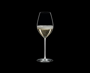 RIEDEL Fatto A Mano Champagne Wine Glass White R.Q. filled with a drink on a black background