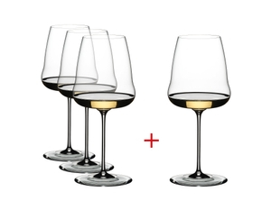 Three plus one RIEDEL Winewings Chardonnay glasses filled with white wine on a white background.