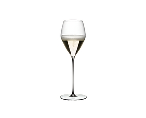 A RIEDEL Veloce Champagne Wine Glass filled with champagne on a white background.