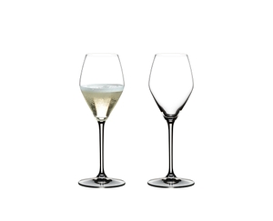 Two RIEDEL Heart to Heart Champagne Glasses. One is unfilled, the other one is filled with Champagne.