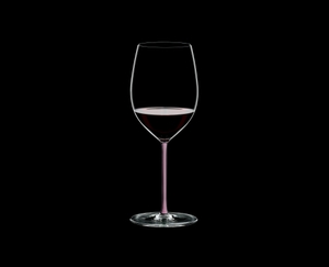 RIEDEL Fatto A Mano R.Q. Cabernet Pink filled with a drink on a black background