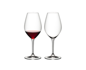 Two RIEDEL Wine Friendly Red Wine glasses side by side against a white background. The glass on the left side is filled with red wine, the glass on the right side is empty.