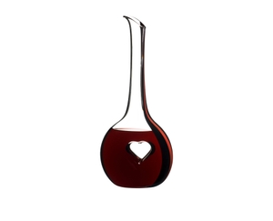 A RIEDEL Black Tie Bliss Decanter with a red stripe filled with red wine on a white background.