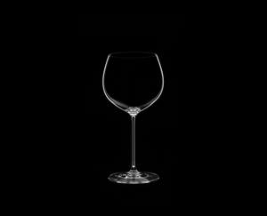 RIEDEL Veritas Oaked Chardonnay filled with a drink on a black background