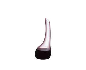 A RIEDEL Cornetto Confetti Decanter Pink filled with red wine on a transparent background. 