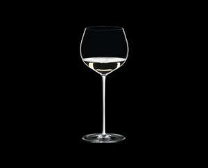 RIEDEL Fatto A Mano Oaked Chardonnay White R.Q. filled with a drink on a black background
