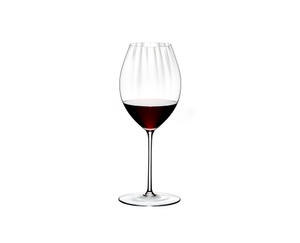 RIEDEL Performance Syrah / Shiraz filled with a drink on a white background