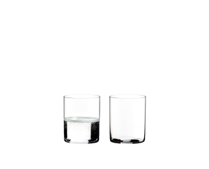 Two RIEDEL Veloce Water glasses one filled with red wine and one unfilled on a white background.