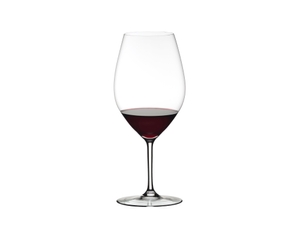 RIEDEL Ouverture Double Magnum filled with a drink on a white background