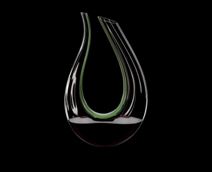 RIEDEL Decanter Amadeo Performance filled with a drink on a black background