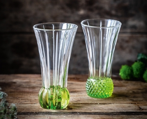 2 NACHTMANN Spring Vase Lime side by side on white background. The upper part of the vase is clear crystal glass while the base is textured lime coloured crystal glass.