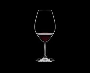RIEDEL Ouverture Double Magnum filled with a drink on a black background
