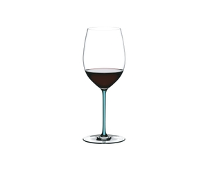 A RIEDEL Fatto A Mano Cabernet with a turquoise stem and filled with red wine.