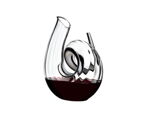 RIEDEL Decanter Curly Fatto A Mano filled with a drink on a white background