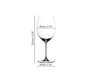 A RIEDEL Veritas Cabernet/Merlot glass on a white background filled with red wine