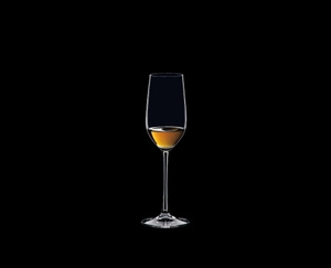 RIEDEL Ouverture Tequila filled with a drink on a black background