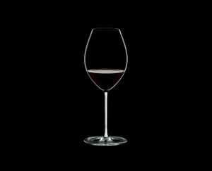 RIEDEL Fatto A Mano Syrah White filled with a drink on a black background