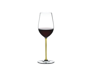 RIEDEL Fatto A Mano Riesling/Zinfandel Yellow R.Q. filled with a drink on a white background