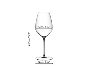 A RIEDEL Veloce Riesling glass filled with white wine on a white background.