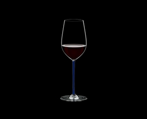 RIEDEL Fatto A Mano Riesling/Zinfandel Dark Blue R.Q. filled with a drink on a black background