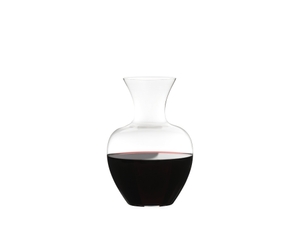 RIEDEL Decanter Apple NY filled with a drink on a white background