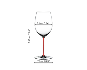 A woman holds a bouquet of roses and two unfilled RIEDEL Fatto A Mano Cabernet/Merlot glasses upside down. One of the glasses has a red stem and the other has a white stem. 