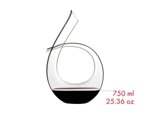 RIEDEL Decanter Black Tie filled with a drink on a white background