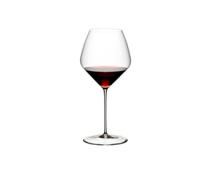 Two RIEDEL Veloce Pinot Noir/Nebbiolo glasses one filled with red wine and an unfilled glass on a white background.