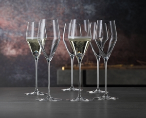 6 unfilled SPIEGELAU Definition Champagne Glasses stand slightly offset side by side on white background