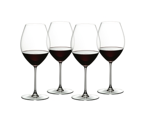 Four red wine filled RIEDEL Veritas Old World Syrah glasses stand slightly offset next to each other