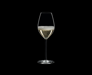 RIEDEL Fatto A Mano Champagne Wine Glass Black filled with a drink on a black background