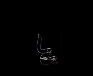 RIEDEL Decanter Boa R.Q. filled with a drink on a black background