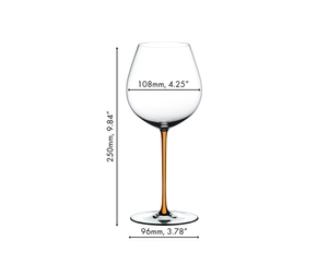 A RIEDEL Fatto A Mano Pinot Noir with an orange stem and filled with red wine on a white background.