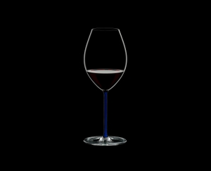 RIEDEL Fatto A Mano Syrah Dark Blue R.Q. filled with a drink on a black background