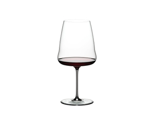 A RIEDEL Winewings Restaurant Cabernet/Merlot glass filled with red wine on a white background.