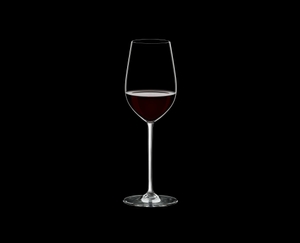 RIEDEL Fatto A Mano Riesling/Zinfandel White R.Q. filled with a drink on a black background