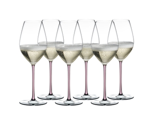 RIEDEL Fatto A Mano Champagne Wine Glass Pink filled with a drink on a white background