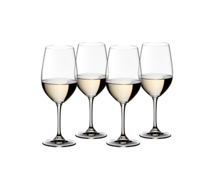 4 RIEDEL Vinum Riesling/Zinfandel glasses filled with white wine stand slightly offset side by side