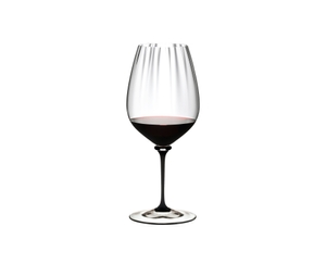 RIEDEL Fatto A Mano Performance Cabernet/Merlot - black stem filled with a drink on a white background