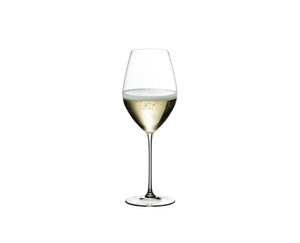 Four RIEDEL Veritas Champagne Wine Glasses with champagne tand side by side or slightly behind each other on a white background.