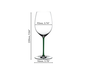A RIEDEL Fatto A Mano Cabernet/Merlot glass in green stands together with a white, a black, a yellow, a red and a dark blue RIEDEL Fatto A Mano Cabernet/Merlot glass on a white set table. 