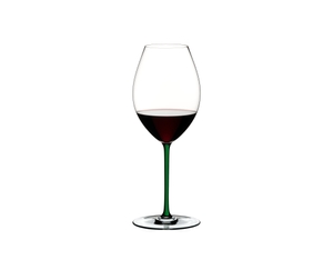 RIEDEL Fatto A Mano Syrah Green R.Q. filled with a drink on a white background