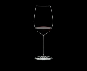 RIEDEL Superleggero Bordeaux Grand Cru filled with a drink on a black background