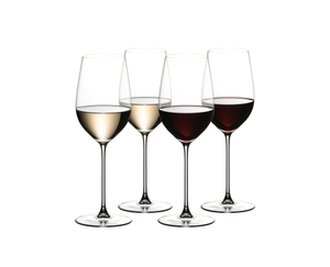 4 RIEDEL Veritas Riesling/Zinfandel glasses stand slightly offset next to each other. Two are filled with white wine the other two are filled with red wine.