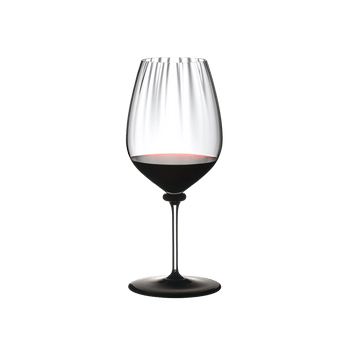 RIEDEL Fatto A Mano Performance Cabernet Black Base filled with a drink on a white background
