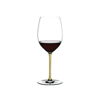 RIEDEL Fatto A Mano Cabernet/Merlot Yellow filled with a drink on a white background