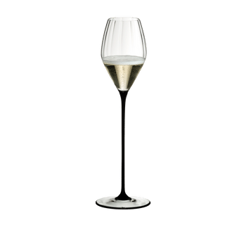 RIEDEL High Performance Champagne Glass Black filled with a drink on a white background