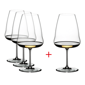 Three plus one RIEDEL Winewings Riesling glasses filled with white wine on a white background.
