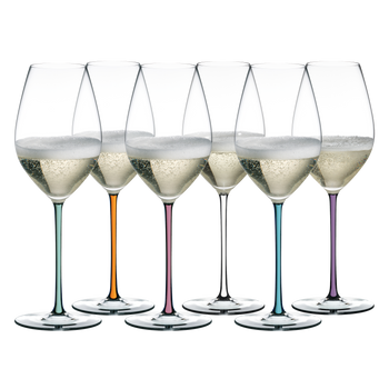 6 champagne filled RIEDEL Fatto A Mano Champagne Wine Glasses with stems which are colored in mint, orange, mauve, white, turquoise and violet stand slightly offset side by side.